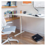 A Humanscale Float height-adjustable standing desk, designed to promote movement and improve health at work.